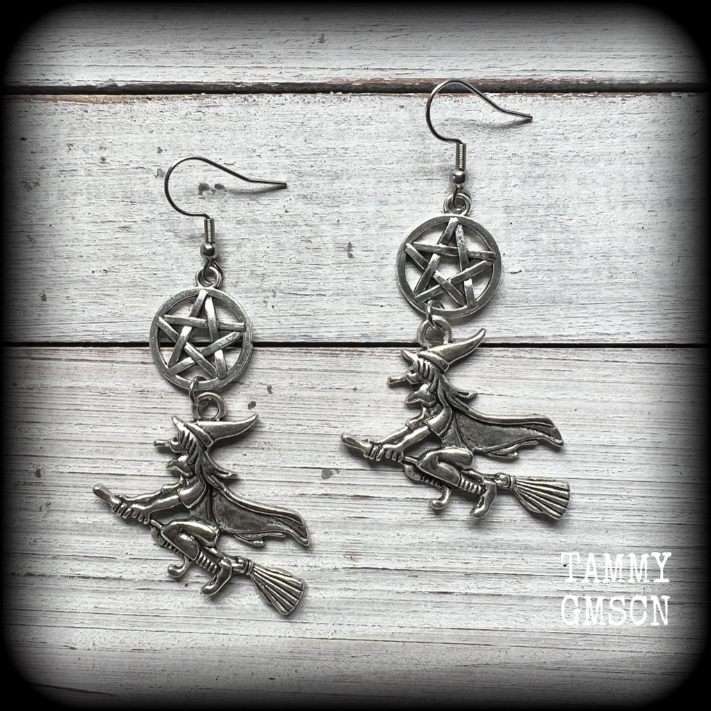 This pair of earrings feature a classic antique silver witch flying on her broomstick dangling from a silver pentagram, are nice and light weight at only 5 grams each, and nice and dangly, measuring just over 7cms from tip to tip.

This pair has been made on stainless steel french hooks, suitable for pierced ears.