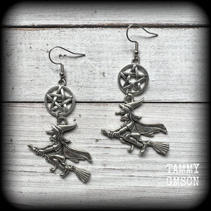This pair of earrings feature a classic antique silver witch flying on her broomstick dangling from a silver pentagram, are nice and light weight at only 5 grams each, and nice and dangly, measuring just over 7cms from tip to tip.

This pair has been made on stainless steel french hooks, suitable for pierced ears.