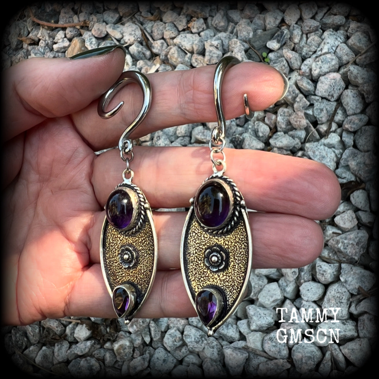 Featuring beautiful purple amethyst gemstones in a boho antique silver setting , this pair of earrings weighs approx 8 grams a piece and measure just under 8cms from tip to tip.

This pair have been made on 6 gauge (4mm) surgical steel full curl hooks, to be worn in stretched lobes.