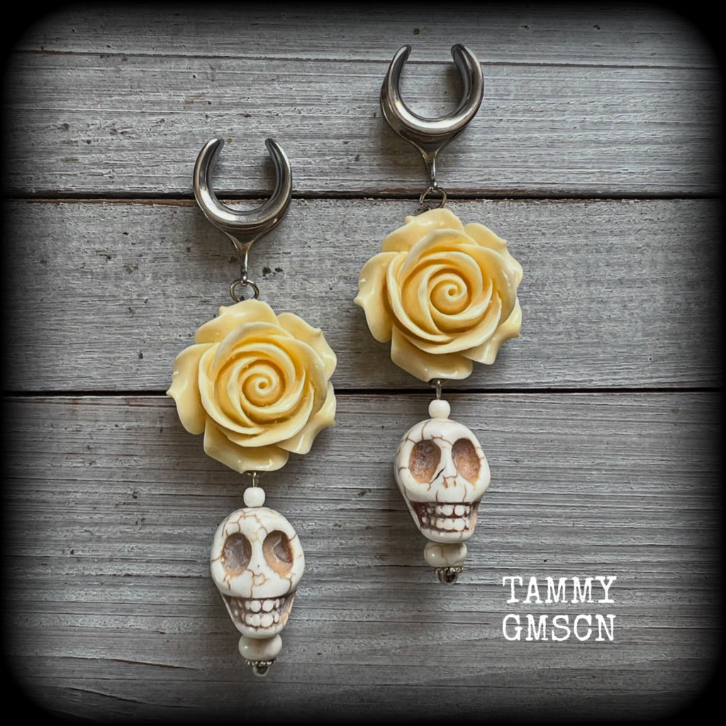 Featuring large bone white stone skulls hanging beneath gorgeous cream coloured roses, these earrings are perfect for Day of the Dead celebrations!

These gorgeous gauged earrings are big and beautiful, weighing in at around 20 grams a piece, and nice and dangly at just under 11cms from tip to tip.

This pair have been made with 5/8” gauge (16mm) surgical steel cradles, suitable for stretched lobes.
