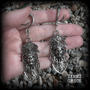 These gorgeous gothic antique silver gauged earrings feature beautiful baroque architecture with the face of Zeus-strong, commanding and masculine, depicted with flowing hair and moustache.

These earrings measure just on 8cms from tip to tip, and weighing approx 15 grams each.

This pair has been made on 6 gauge (4mm) surgical steel full curls, to be worn in stretched lobes.