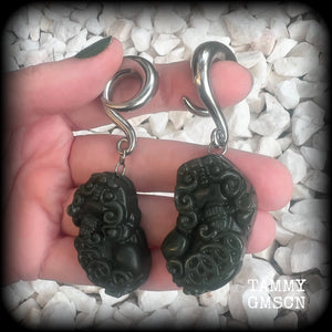 These gorgeous earrings are made from carved Lantian jade featuring the beautiful mythological lion dog, the Pi Xiu, weighing approx 34 grams a piece and measure just over 7cms from tip to tip.

This pair have been made with 0 gauge (8mm) surgical steel full curl hooks, to be worn in stretched lobes.