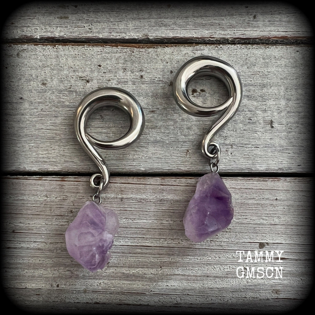These gorgeous gauged earrings feature beautiful purple raw amethyst gemstones, measuring just under 6cms from tip to tip, and weighing approx 10 grams each, not too heavy...

This pair have been made on 2 gauge (6mm) surgical steel full curl hooks, to be worn in stretched lobes.
