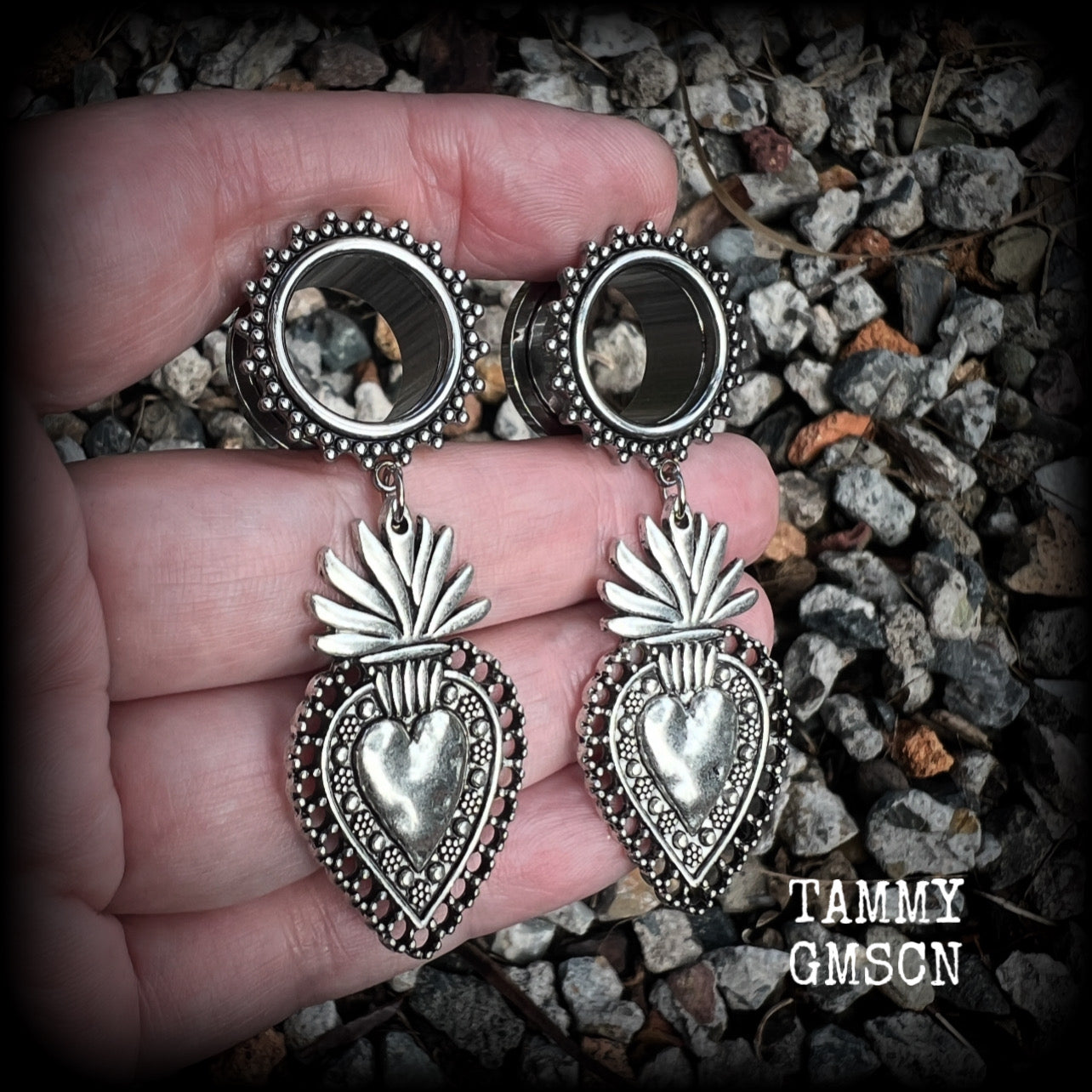 These gorgeous tunnel earrings feature beautiful antique silver sacred hearts, are nice and lightweight, weighing approx 10 grams each and measure just under 7cms from tip to tip.

This pair has been made with 9/16" (14mm) gauge ornate surgical steel screw fit tunnels.