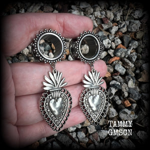 These gorgeous tunnel earrings feature beautiful antique silver sacred hearts, are nice and lightweight, weighing approx 10 grams each and measure just under 7cms from tip to tip.

This pair has been made with 9/16" (14mm) gauge ornate surgical steel screw fit tunnels.