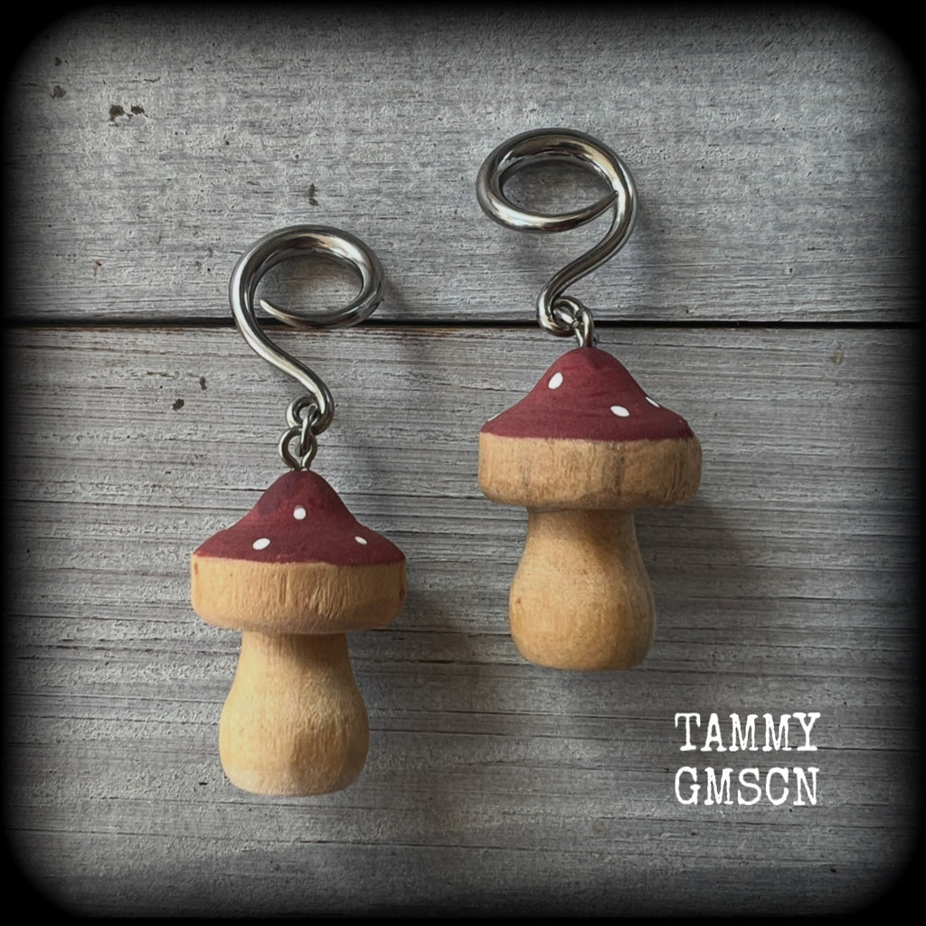 This pair of earrings features gorgeous dusty pink wood mushrooms, nice and light weight at 7 grams a piece, and nice and dangly at just on 6.5cms from tip to tip.

This pair has been made on 6 gauge (4mm) surgical steel full curl hooks, suitable for stretched lobes.