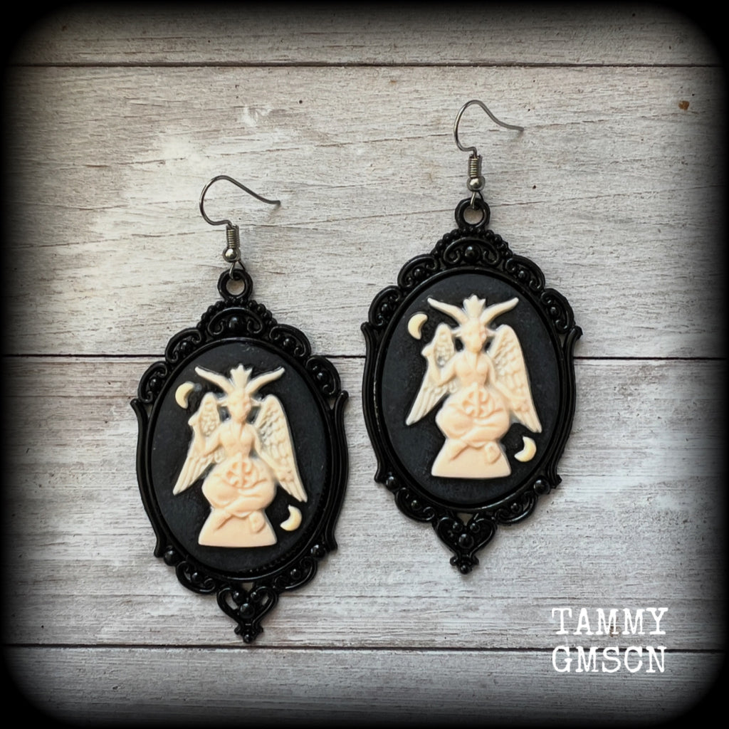 These gorgeous gothic earrings feature ivory Baphomets enclosed in beautiful black enamel framea, are light weight (11 grams a piece) and nice and dangly, measuring just over 8cms from tip to tip.

This pair has been made on stainless steel french hooks, suitable for pierced ears.

