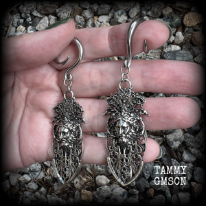 These gorgeous gothic antique silver gauged earrings feature beautiful baroque architecture with the face of Zeus-strong, commanding and masculine, depicted with flowing hair and moustache.

These earrings measure just on 8cms from tip to tip, and weighing approx 15 grams each.

This pair has been made on 6 gauge (4mm) surgical steel full curls, to be worn in stretched lobes.