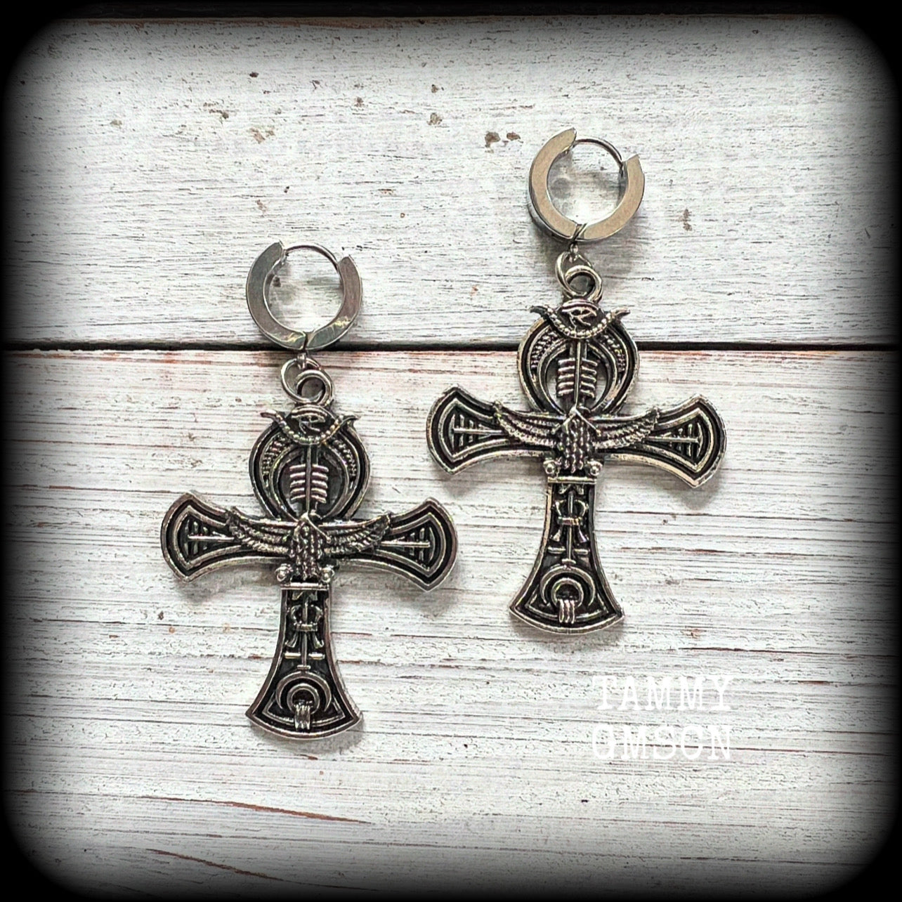 These gorgeous antique silver Egyptian ankh cross earrings measure just on 6cms from tip to tip, and are nice and light weight, at 8 grams each.

This pair have been made on stainless steel huggies-suitable for pierced ears. 