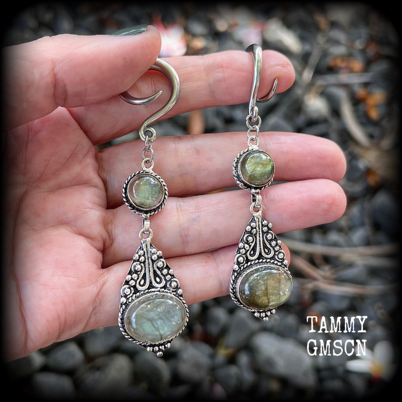 Made with shimmering polished labradorite gemstones, measuring 8.5cms from tip to tip, and weighing approx 10 grams each, not too heavy...
These earrings have been made on 6 gauge (4mm) surgical steel full curl hooks, to be worn in stretched lobes.