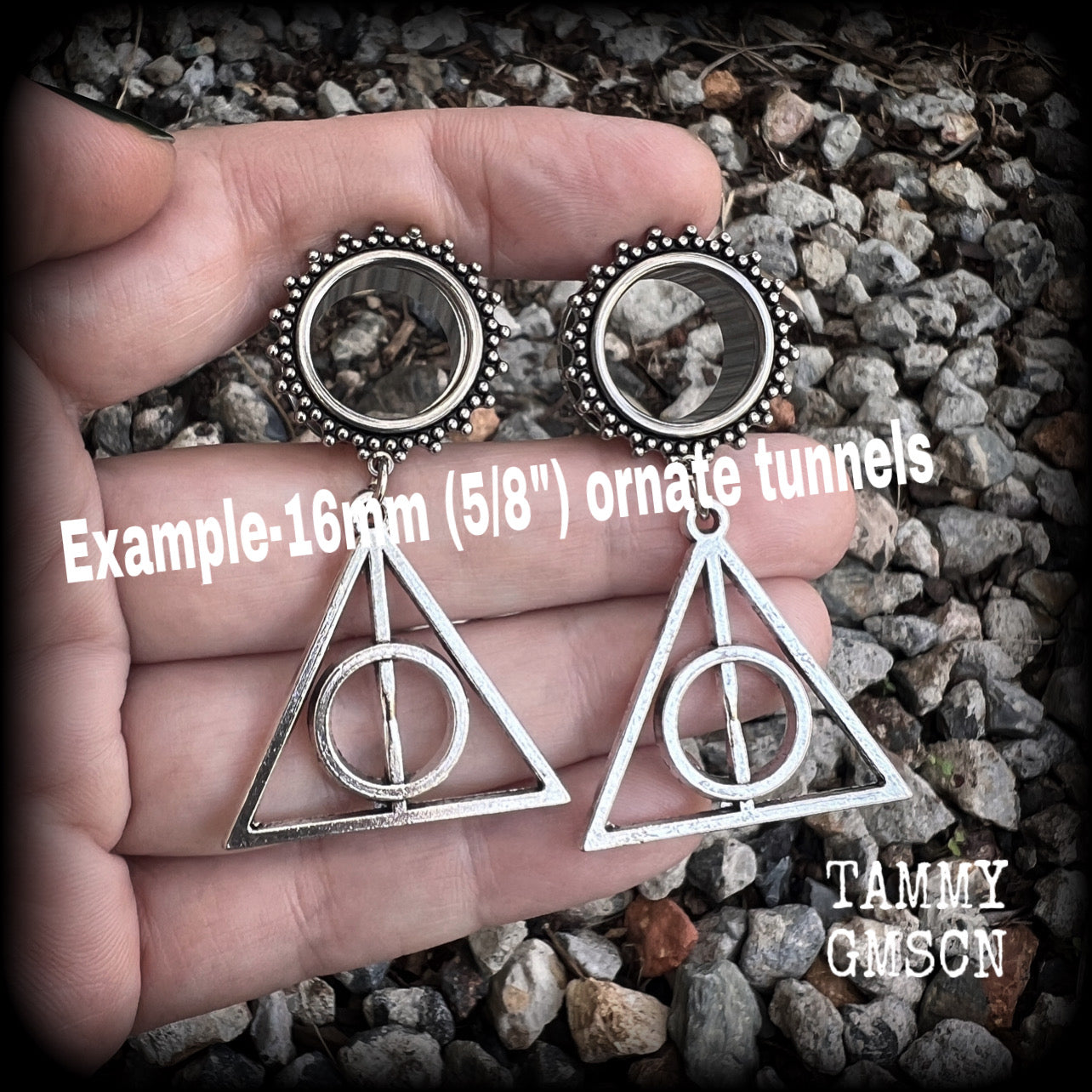 Measuring just on 6 cms from tip to tip, and weighing approx 10 grams a piece, this pair of adorable Harry Potter tunnel dangles features a classic antique silver Deathly Hallows charm.

 This pair has been made with gorgeous boho 5/8" gauge (16mm) ornate surgical steel screw fit tunnels, suitable for stretched lobes. 