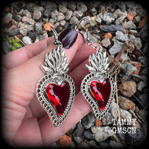 These beautiful red enamel and antique silver sacred heartearrings are nice and lightweight at approx 5 grams a piece, measuring just over 7cms from tip to tip.


This pair has been made on stainless steel french hooks to be worn through pierced ears.