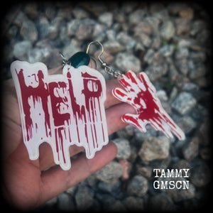 These awesome horror movie inspired earrings feature a bloodied hand print alongside ‘HELP’ finger painted in blood, measuring approx 7.5cms from tip to tip, and weigh only a few grams each.

This pair has been made with stainless steel french hooks, suitable for pierced ears.