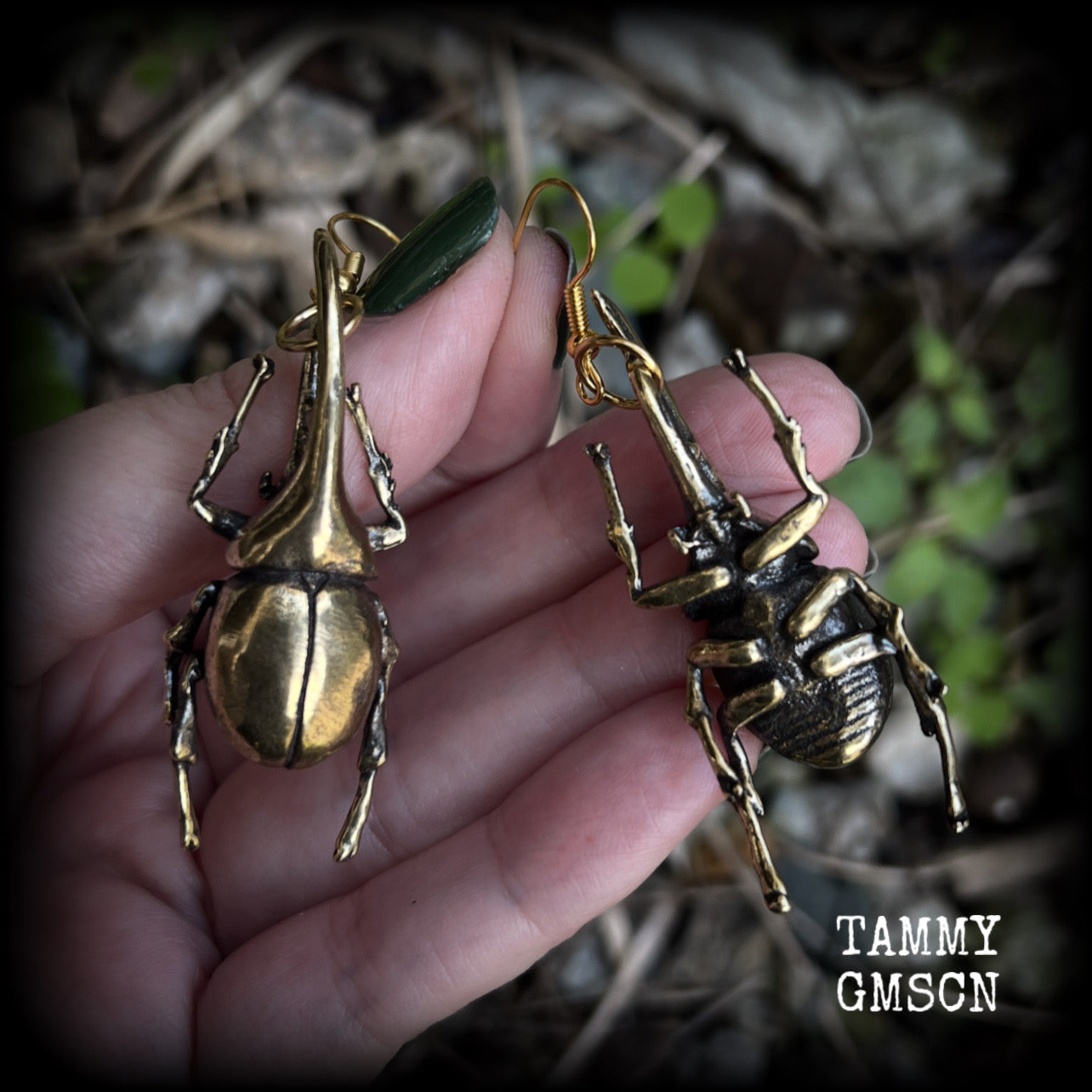 These gorgeous brass Hercules beetle earrings are big and beautiful! Weighing approx 19 grams each, this pair measures 7cms from tip to tip.

This pair has been made on antique gold french hooks, suitable for pierced ears.