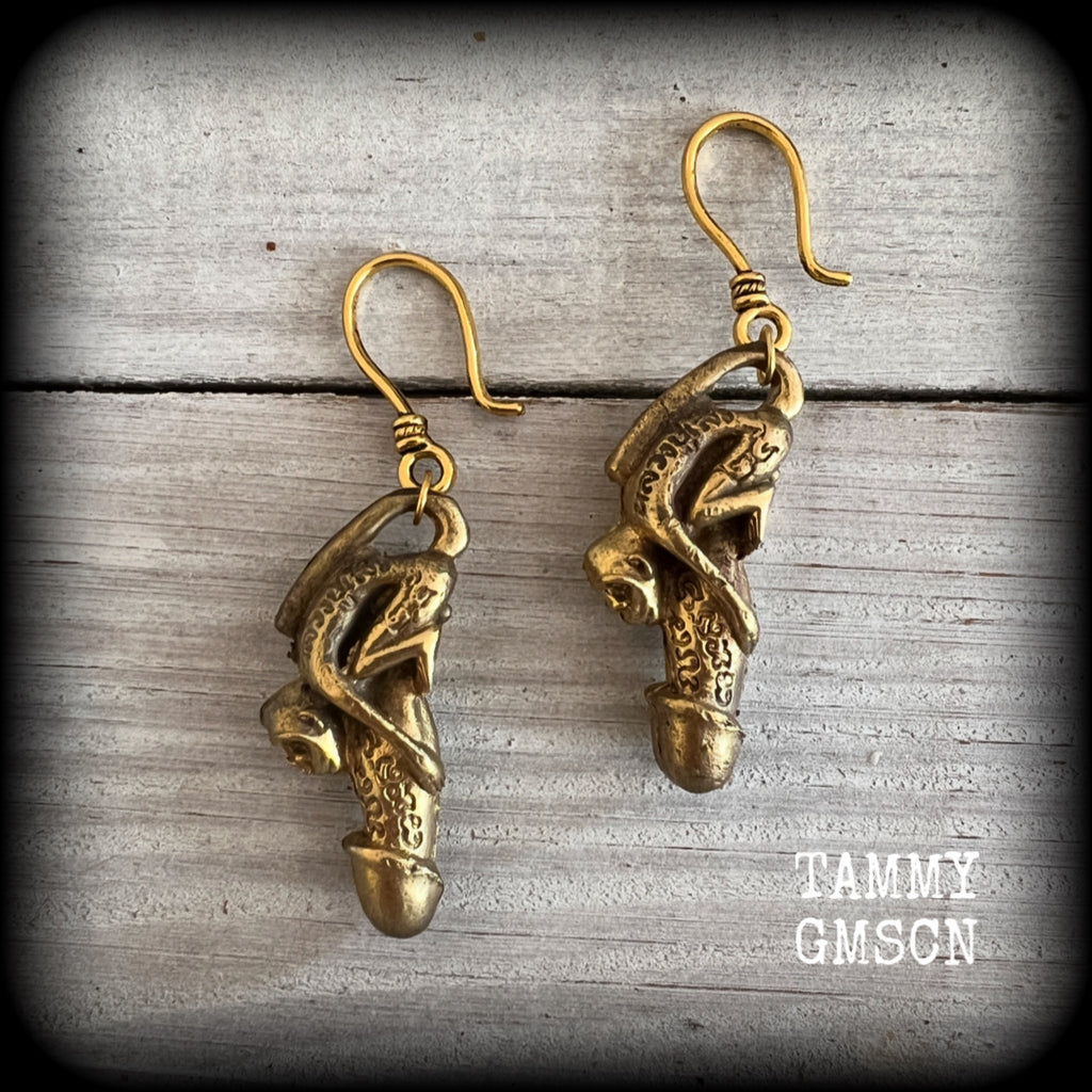 Featuring a brass Paladkhik penis charm, worn to attract love sex wealth and success and to protect from evil, these unique earrings weigh 19 grams each and measure just over 6cms from tip to tip.

This pair have been made on small antique antique gold shephard hooks, to be worn through stretched ears with silicone earlets from 8 gauge (3mm).