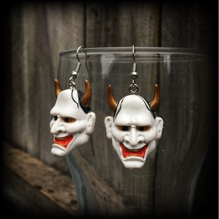 Featuring traditional red white and gold carved wood hannya mask charms, these unique earrings measure just on 6cms from tip to tip, and weigh only 5 grams each.

This pair have been made with stainless steel french hooks, for pierced ears.