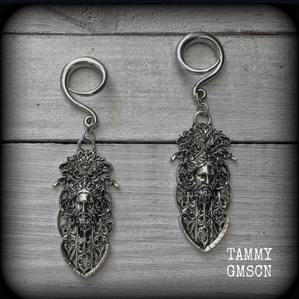 These gorgeous gothic antique silver gauged earrings feature beautiful baroque architecture with the face of Zeus-strong, commanding and masculine, depicted with flowing hair and moustache.

These earrings measure just on 8cms from tip to tip, and weighing approx 15 grams each.

This pair has been made on 6 gauge (4mm) surgical steel full curls, to be worn in stretched lobes.