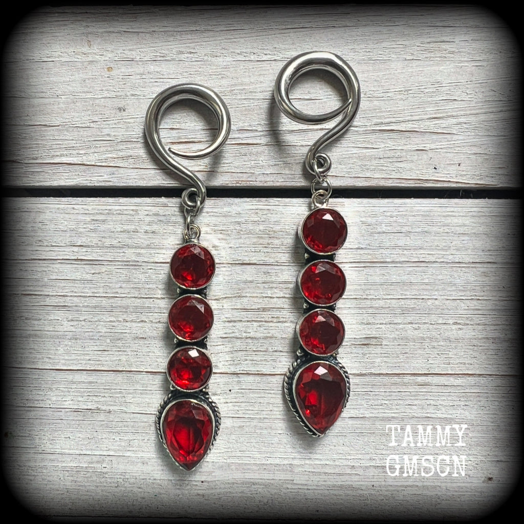These stunning dangly gauged earrings feature gorgeous deep red faceted garnet gemstones in an ornate antique silver setting, measuring just over 8cms from tip to tip, and weigh approx 9 grams each.

This pair have been made with 6 gauge (4mm) surgical steel full curl hooks, to be worn in stretched lobes.