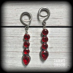 These stunning dangly gauged earrings feature gorgeous deep red faceted garnet gemstones in an ornate antique silver setting, measuring just over 8cms from tip to tip, and weigh approx 9 grams each.

This pair have been made with 6 gauge (4mm) surgical steel full curl hooks, to be worn in stretched lobes.