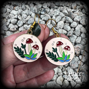 These adorable antique gold and enamel toadstool earrings measure in at just under 5cm, are nice and light, weighing only a few grams each.

This pair has been made with antique gold french hooks, suitable for pierced ears.