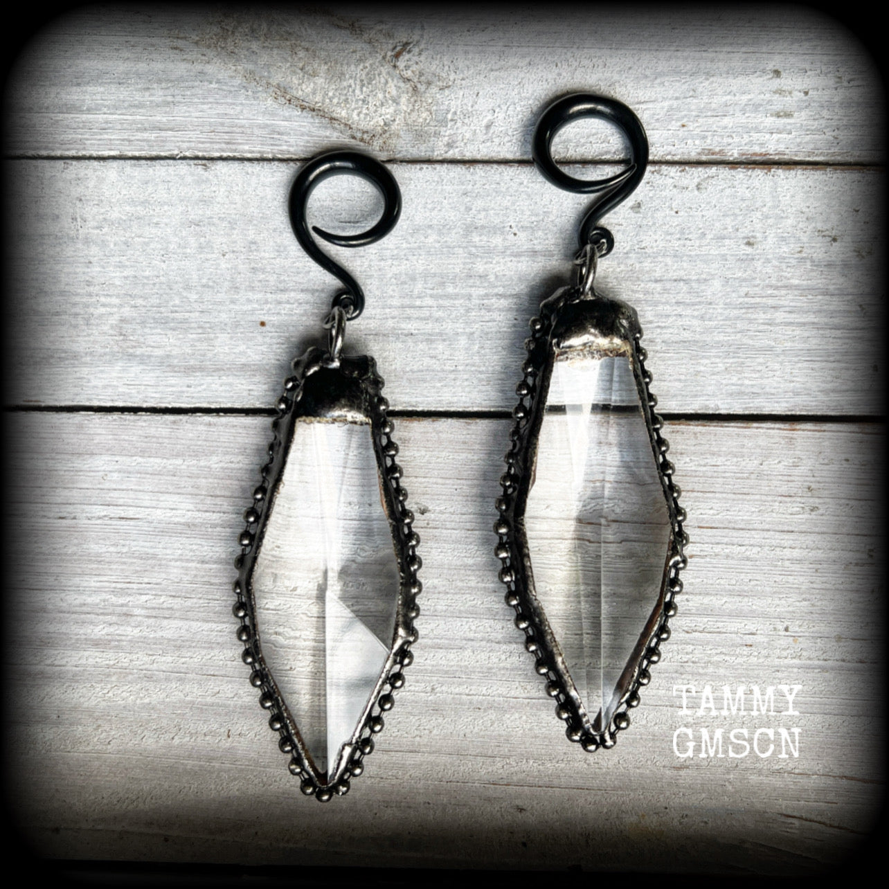 These gorgeous dangly gothic glass earrings have been made with gorgeous chunky faceted clear glass pieces, measuring just on 10 cms from tip to tip, and weighing approx 24 grams each.

These earrings have been made on 6 gauge (4mm) surgical steel full curls, to be worn in stretched lobes.