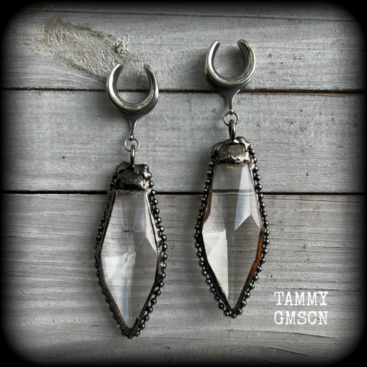 These gorgeous dangly glass earrings have been made with gorgeous chunky faceted clear glass pieced, measuring 10.5 cms from tip to tip, and weighing approx 26 grams each.

These earrings have been made on 5/8" gauge (16mm) surgical steel cradles, to be worn in stretched lobes.