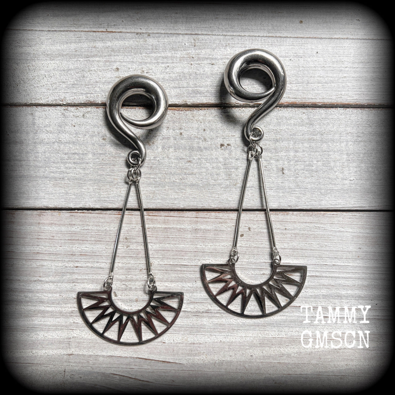 Inspired by Ishtar, Mesopotamian Goddess of love, beauty, sex and war, this beautiful pair of earrings features stainless steel tribal sunray pendants.

These earrings are nice and light weight, weighing approx 15 grams a piece and measure just over 10cms from tip to tip.

This pair has been made on 0 gauge (8mm) surgical steel full curl hooks, suitable for stretched lobes.