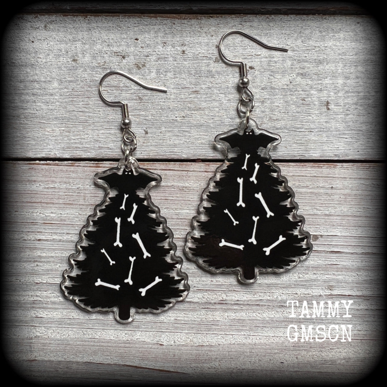 These adorable black gothic Creepmas Christmas tree earrings are decorated with bones and topped with a spooky black bat!!

These earrings are nice and dangly, measuring 7cms from tip to tip and nice and lightweight, weighing only a few grams each.

This pair has been made on stainless steel french hooks, suitable for pierced ears.