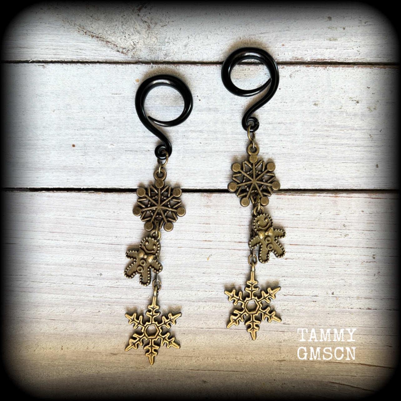These awesome gothic Christmas gauged earrings feature antique bronze snowflakes and gingerbread men, are nice and dangly, measuring just on 9 cms from tip to tip and weighing approx 7 grams each, super light weight.

This pair has been made on 6 gauge (4mm) surgical steel full curl hooks, to be worn in stretched lobes.