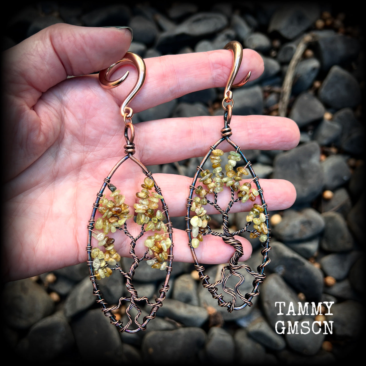 These beautiful Tree of life gauged earrings feature gorgeous wire wrapped trees with dusty green peridot gemstone chips, super dangly measuring just over 12cms from tip to tip, and weighing approx 20 grams each.

This pair has been made on 2 gauge (6mm) surgical steel full curl hooks, suitable for stretched lobes.