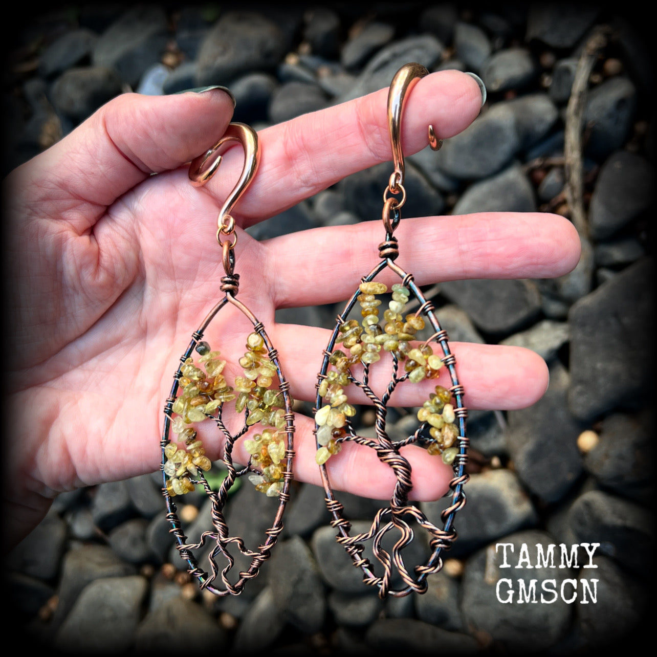 These beautiful Tree of life gauged earrings feature gorgeous wire wrapped trees with dusty green peridot gemstone chips, super dangly measuring just over 12cms from tip to tip, and weighing approx 20 grams each.

This pair has been made on 2 gauge (6mm) surgical steel full curl hooks, suitable for stretched lobes.
