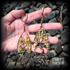 These beautiful Tree of life gauged earrings feature gorgeous wire wrapped trees with dusty green peridot gemstone chips, super dangly measuring just over 12cms from tip to tip, and weighing approx 20 grams each.

This pair has been made on 2 gauge (6mm) surgical steel full curl hooks, suitable for stretched lobes.