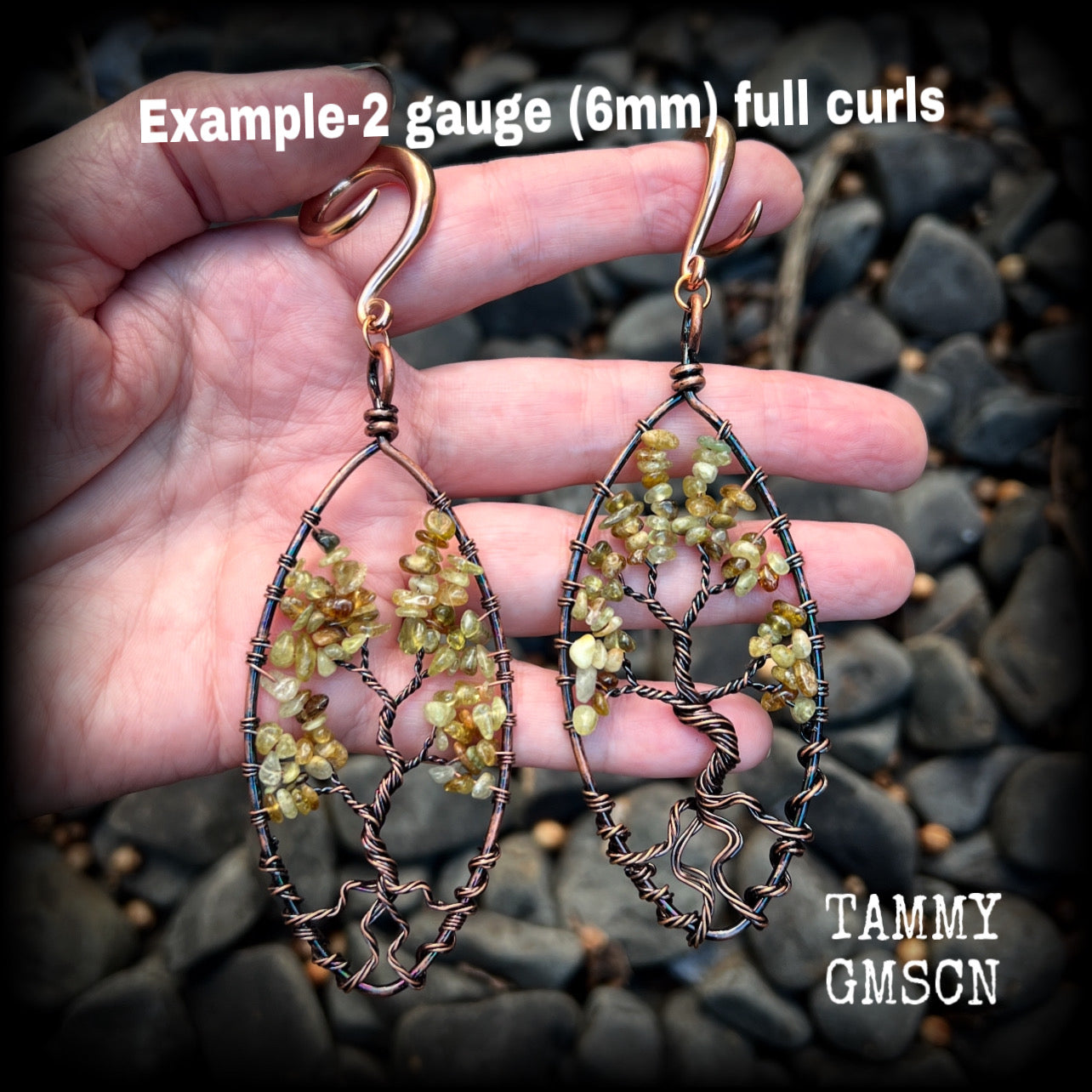 These beautiful Tree of life gauged earrings feature gorgeous wire wrapped trees with dusty green peridot gemstone chips, super dangly measuring just over 12cms from tip to tip, and weighing approx 20 grams each.

This pair has been made on 2 gauge (6mm) surgical steel full curl hooks, suitable for stretched lobes.