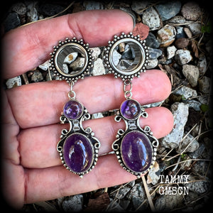 These gorgeous tunnel earrings have been made with beautiful polished amethyst gemstones in gorgeous antique silver boho settings.
These earrings are beautifully light weight, weighing approx 13 grams each and measure just on 6cms from tip to tip.

This pair have been made with 9/16” gauge (14mm) ornate surgical steel screw fit tunnels.