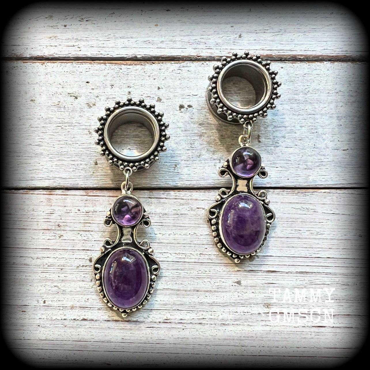 These gorgeous tunnel earrings have been made with beautiful polished amethyst gemstones in gorgeous antique silver boho settings.
These earrings are beautifully light weight, weighing approx 13 grams each and measure just on 6cms from tip to tip.

This pair have been made with 9/16” gauge (14mm) ornate surgical steel screw fit tunnels.