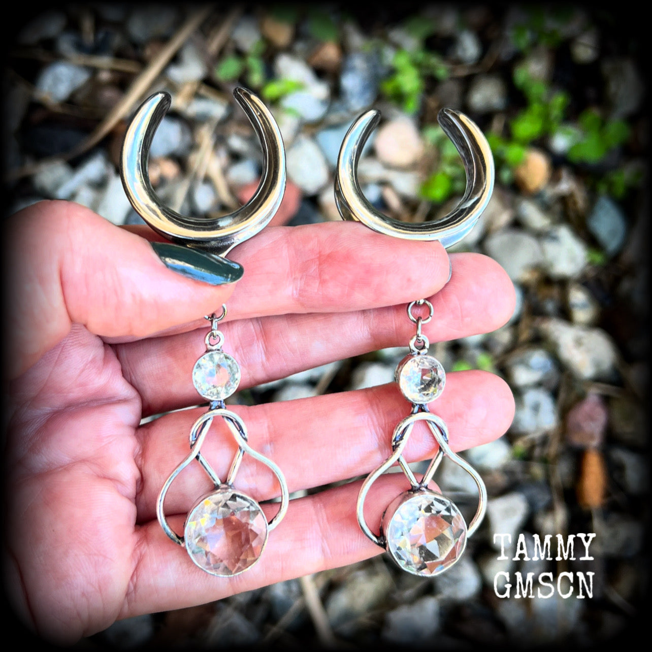 Featuring shimmering clear topaz gemstones in a beautiful antique silver knotwork setting, these gorgeous earrings weigh in at 14 grams a piece, and are nice and dangly at just under 9cms from tip to tip.

This pair has been made on 1” gauge (25mm) surgical steel cradles, suitable for stretched lobes.