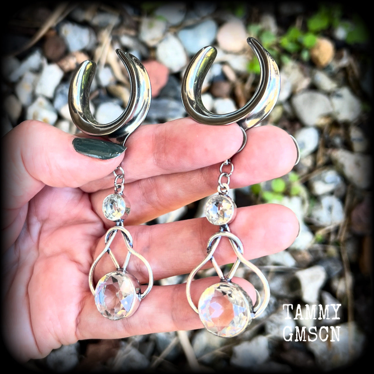 Featuring shimmering clear topaz gemstones in a beautiful antique silver knotwork setting, these gorgeous earrings weigh in at 14 grams a piece, and are nice and dangly at just under 9cms from tip to tip.

This pair has been made on 1” gauge (25mm) surgical steel cradles, suitable for stretched lobes.