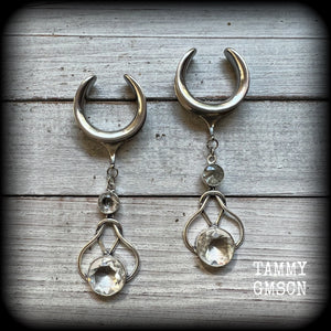 Featuring shimmering clear topaz gemstones in a beautiful antique silver knotwork setting, these gorgeous earrings weigh in at 14 grams a piece, and are nice and dangly at just under 9cms from tip to tip.

This pair has been made on 1” gauge (25mm) surgical steel cradles, suitable for stretched lobes.