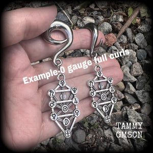 Our 'Tree of Life' gauged earrings feature stunning Kabalistic Tree of Life charms complete with sephiroth symbols. These earrings and are nice and dangly at just on 7cms, and weigh 8 grams a piece.
This pair has been made on 0 gauge (8mm) surgical steel full curl hooks, to be worn in stretched lobes.
