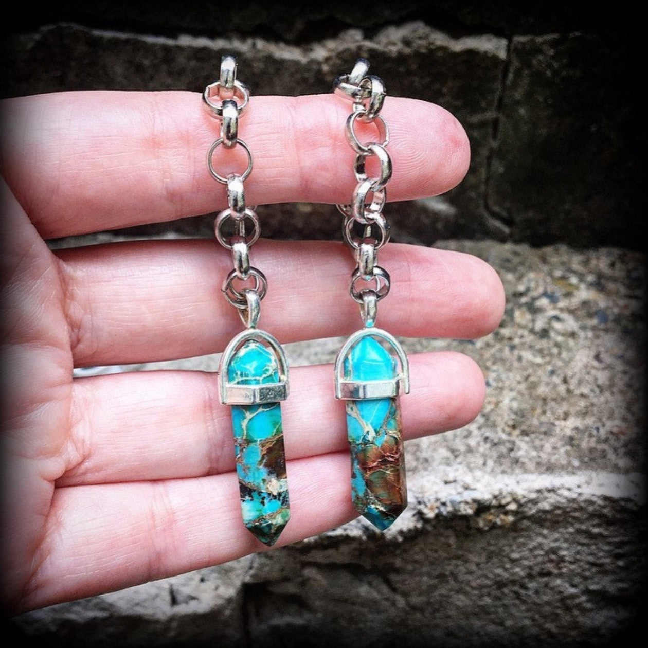 These earrings feature gorgeous turquoise sea sediment jasper pendulums, measuring just on 8cms from tip to tip, and are nice and light weight, weighing only 8 grams each.

This pair has been made with our chunky antique silver chain/lobster clasp 10mm option, suitable to be worn in stretched lobes with silicone earlets from 00 gauge (10mm).