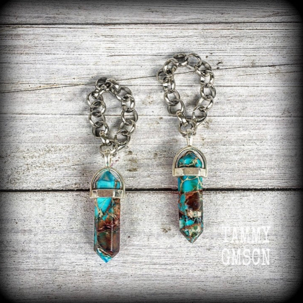 These earrings feature gorgeous turquoise sea sediment jasper pendulums, measuring just on 8cms from tip to tip, and are nice and light weight, weighing only 8 grams each.

This pair has been made with our chunky antique silver chain/lobster clasp 10mm option, suitable to be worn in stretched lobes with silicone earlets from 00 gauge (10mm).