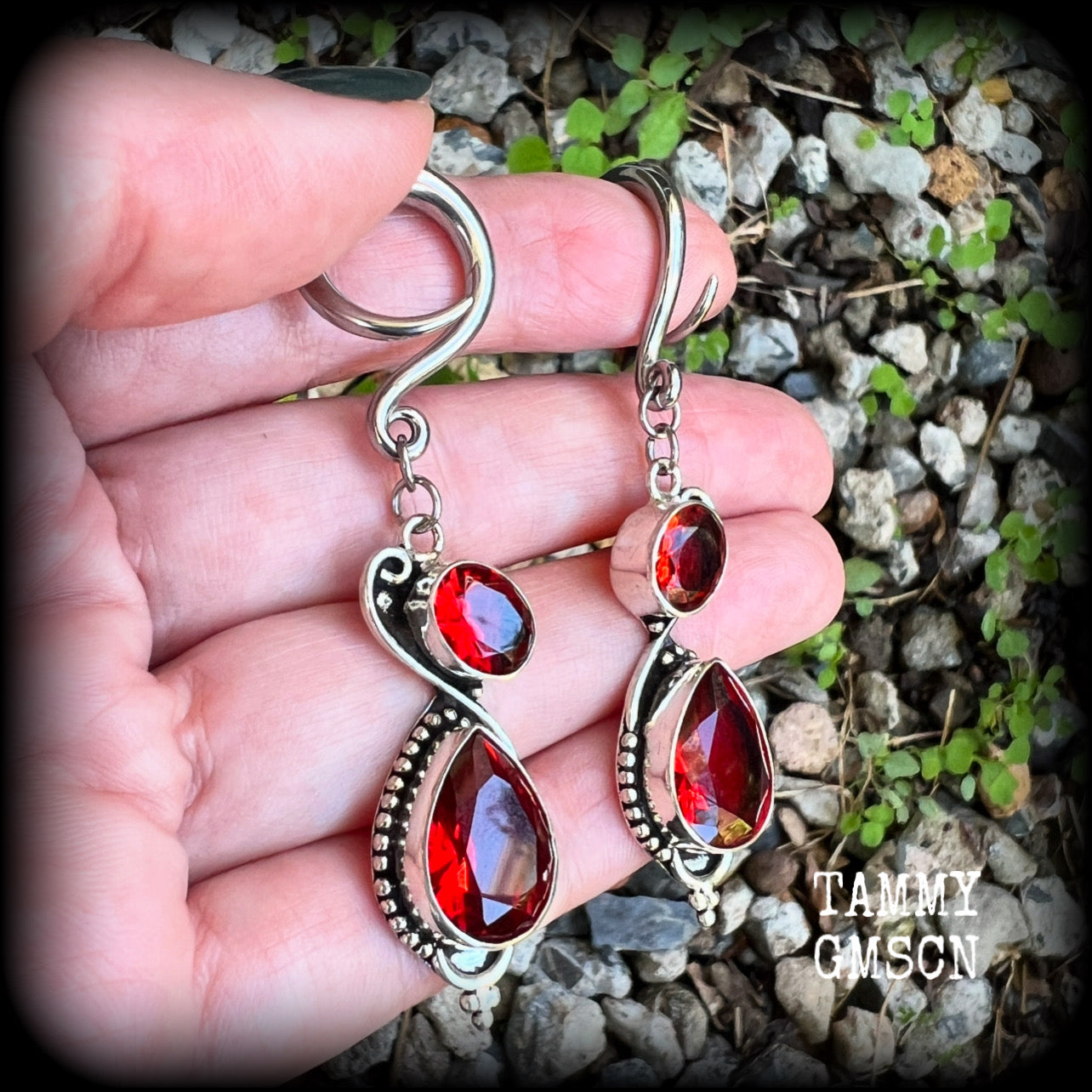 These gorgeous gypsy boho gauged earrings have been made with deep red faceted garnet gemstones in an ornate antique silver setting, measuring just over 7cms from tip to tip, and weighing approx 9 grams each, nice and light weight.

These earrings have been made on 6 gauge (4mm) surgical steel full curl hooks, to be worn in stretched lobes.