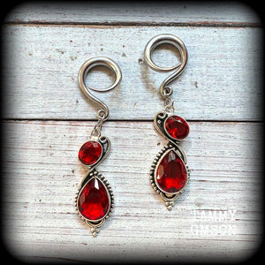 These gorgeous gypsy boho gauged earrings have been made with deep red faceted garnet gemstones in an ornate antique silver setting, measuring just over 7cms from tip to tip, and weighing approx 9 grams each, nice and light weight.

These earrings have been made on 6 gauge (4mm) surgical steel full curl hooks, to be worn in stretched lobes.