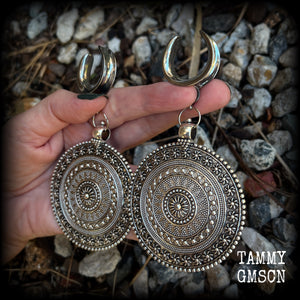 These big beautiful antique silver mandala gauged earrings are gorgeous!! Weighing in at approx 33grams a piece, measuring just on 12cms from tip to tip, this pair of gauged earrings are lovely and dangly but not too heavy.

This pair have been made on 1” gauge (25mm) surgical steel cradles, suitable for stretched lobes.
