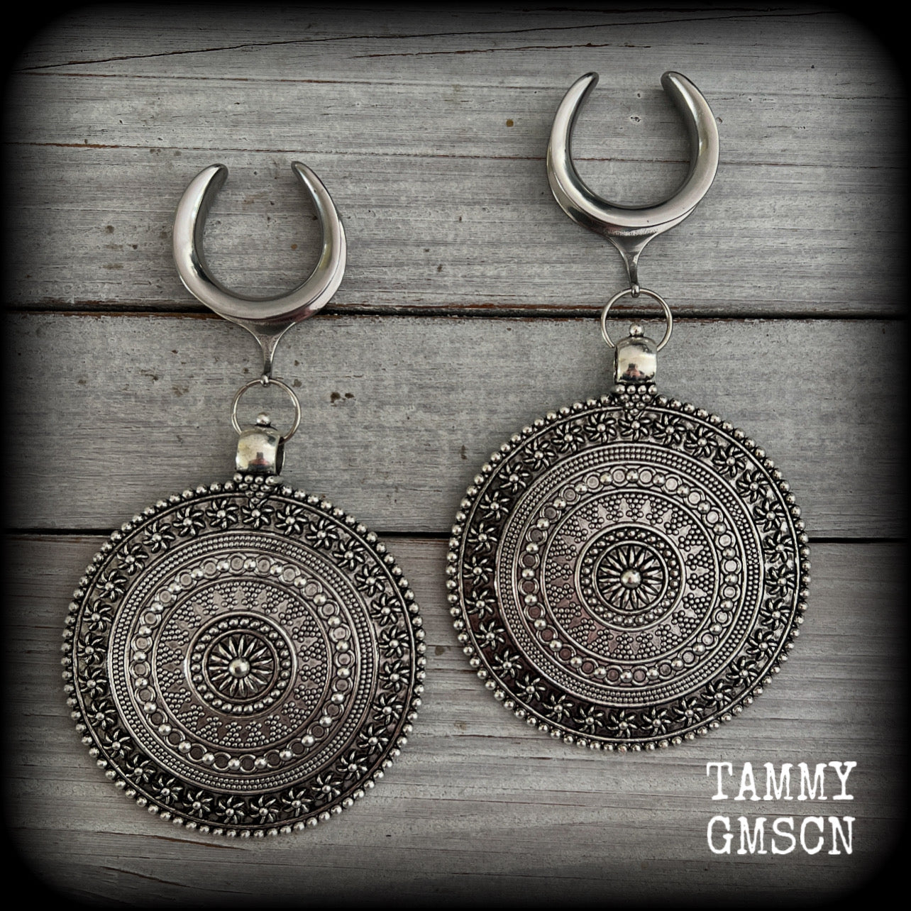 These big beautiful antique silver mandala gauged earrings are gorgeous!! Weighing in at approx 33grams a piece, measuring just on 12cms from tip to tip, this pair of gauged earrings are lovely and dangly but not too heavy.

This pair have been made on 1” gauge (25mm) surgical steel cradles, suitable for stretched lobes.
