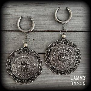 These big beautiful antique silver mandala gauged earrings are gorgeous!! Weighing in at approx 33grams a piece, measuring just on 12cms from tip to tip, this pair of gauged earrings are lovely and dangly but not too heavy.

This pair have been made on 1” gauge (25mm) surgical steel cradles, suitable for stretched lobes.
