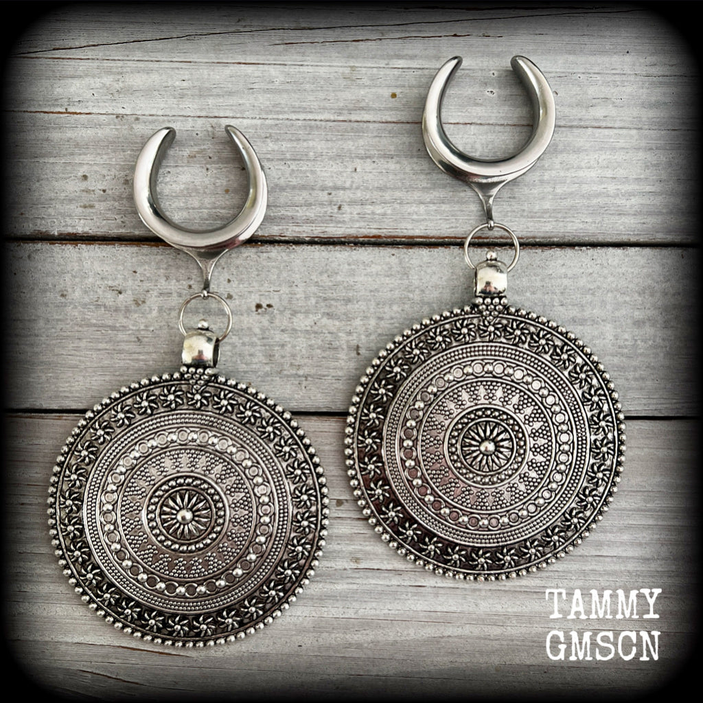 These big beautiful antique silver mandala gauged earrings are gorgeous!! Weighing in at approx 33grams a piece, measuring just on 12cms from tip to tip, this pair of gauged earrings are lovely and dangly but not too heavy.

This pair have been made on 1” gauge (25mm) surgical steel cradles, suitable for stretched lobes.
