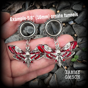 These awesome tunnel earrings feature antique silver and red enamel deathshead moths, are nice and light weight, weighing in at 10 grams each and measure just over 5cms from tip to tip.

This pair have been made with 5/8” gauge (16mm) surgical steel screw fit ornate tunnels.