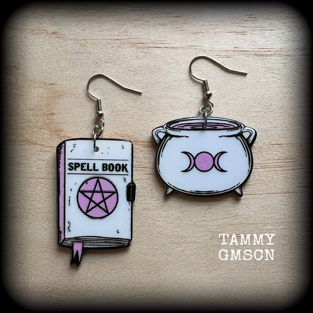 These awesome spooky cute pastel goth earrings feature baby pink and white witches spell books and cauldron charms, are nice and light weight at only a few grams each, and are nice and dangly, measuring just on 6cms from tip to tip.

This pair has been made on with stainless steel french hooks, suitable for pierced ears. 