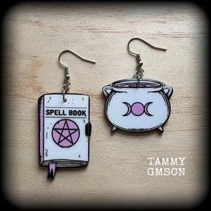 These awesome spooky cute pastel goth earrings feature baby pink and white witches spell books and cauldron charms, are nice and light weight at only a few grams each, and are nice and dangly, measuring just on 6cms from tip to tip.

This pair has been made on with stainless steel french hooks, suitable for pierced ears. 